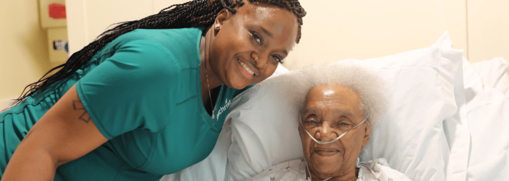 Patient with hospice aide smiling